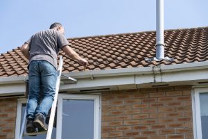 man inspecting gutters in barrie