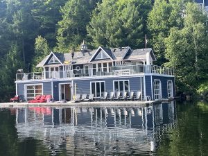 photo of house on the shoreline of a lake