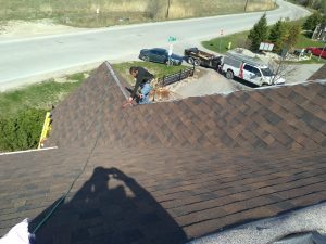 Roofing company installs new shingles