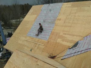 Roofing company installs new shingles